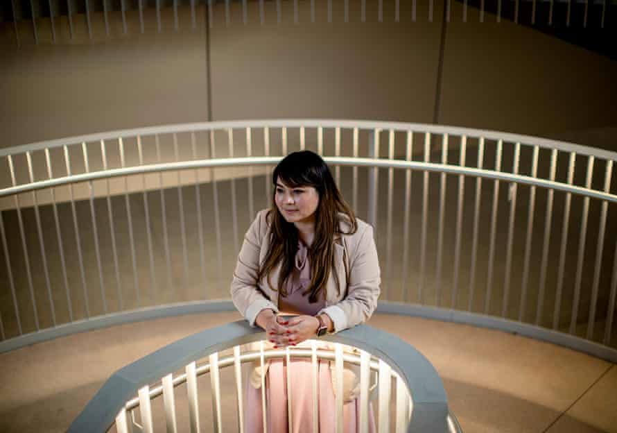 Woman standing by spiral staircase