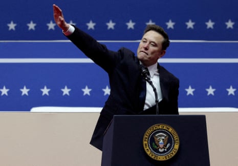 a man in a suit extends his right hand up with a straight arm