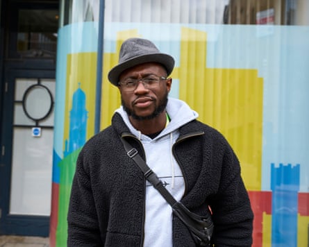 Dara Adakoy wearing hat against colourful backdrop