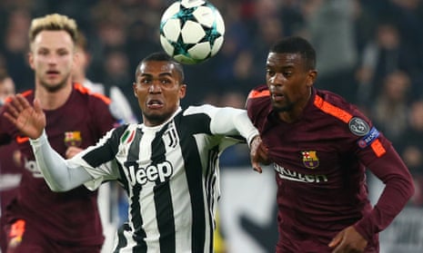 Juventus’ Douglas Costa races Barcelona’s Nelson Semedo for the ball.