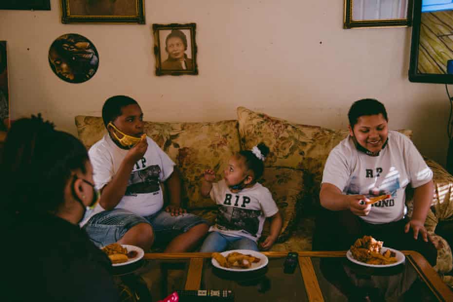 David Phillips’ grandchildren Dejuan Allen, Leilanni Allen, and Donnell Allen eat dinner at Phillips’ home in Chico. Bullet holes are still visible in the walls and furniture in his living room.