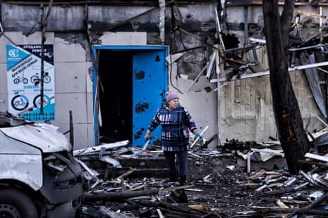 A woman stands at the entrance to a damaged multi-story apartment building after a combined attack by Russian forces on in Dobropillia, Donetsk region, Ukraine.