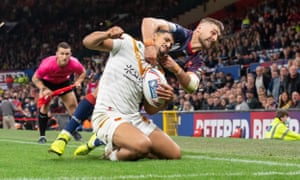 St Helens’s Tommy Makinson prevents Catalans’ Fouad Yaha from scoring a try by hauling him into touch.