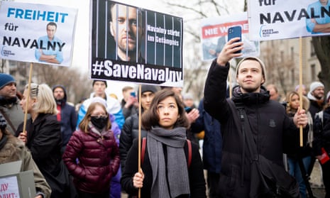 People attend a demonstration demanding the release of Alexei Navalny in Berlin, Germany on Tuesday.