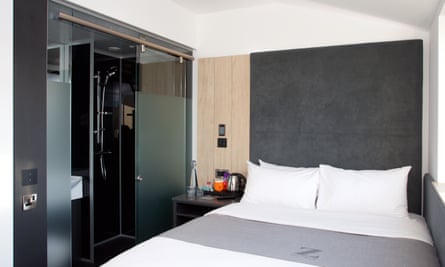 Bedroom, with shower unit in corner of room at Z Hotel Bath, Bath, UK.