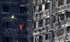 Members of the emergency services work inside burnt out remains of the Grenfell tower block in north Kensington, London, on 18 June.