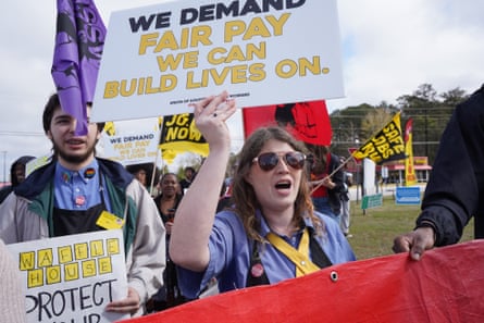 a woman holding a sign at a protest
