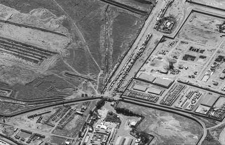 a satellite image shows a line of trucks waiting