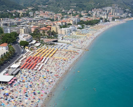 Crowded sandy beach in Spotorno, Italy.