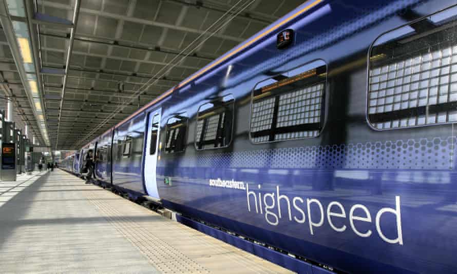 Shot down a platform of a rake of sleek modern dark blue carriages with paler doors, bearing the logo 'Southeastern highspeed'