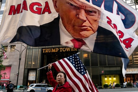 A Trump supporter holds up a flag at Trump Tower in New York.
