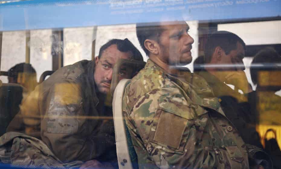 Ukrainian servicemen sit in a bus after they were evacuated from the  Azovstal steel plant