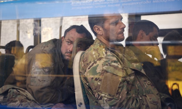 Ukrainian servicemen sit in a bus after they were evacuated from the Azovstal steel plant