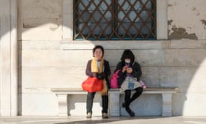 A tourist wears a protective face mask in Venice.