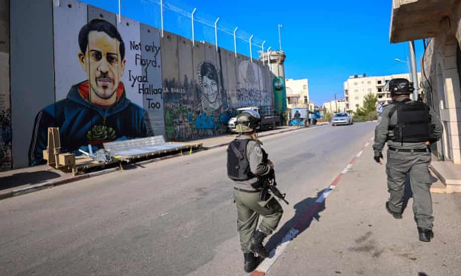 Israeli soldiers patrol next to the separation barrier in Bethlehem, West Bank