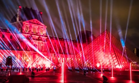 Lights are projected on the Louvre’s pyramid for a ‘United at Home’ performance of the French DJ David Guetta, which will be broadcast on New Year’s Eve.
