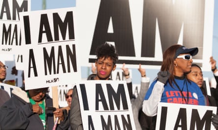 People carrying union signs and signs with the ‘I Am A Man’ slogan from the 1968 sanitation workers strike gather for a rally on Beale Street in Memphis.