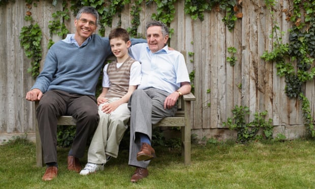 Family portrait of grandfather, father and son in garden