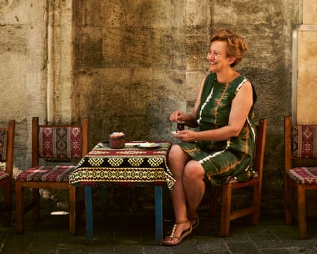 Author and cook Özlem Warren drinking tea at a small table in Turkey