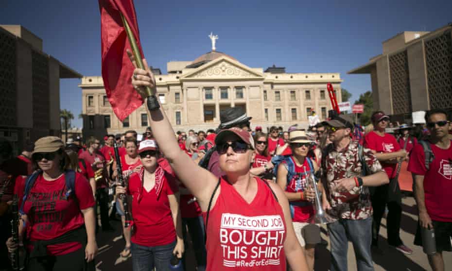 Jill Schroeder, a teacher at Gilbert Public Schools, leads the RedForEd Spirit Band during the sixth day of the Arizona teacher walkout at the Arizona state capitol in Phoenix.