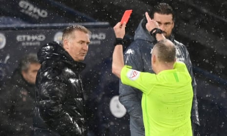 The Aston Villa manager, Dean Smith, is shown the red card by the referee in the pouring rain for protesting against Manchester City’s first goal last week.