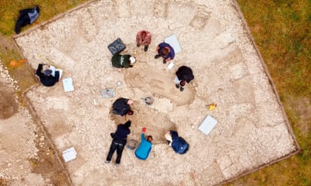 Aerial view of people exavating the grave