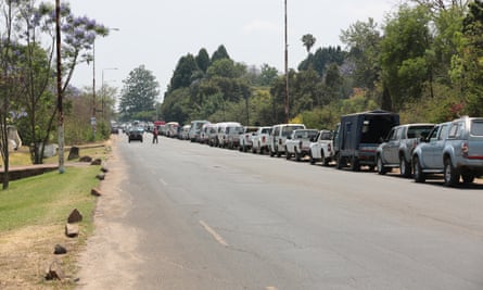 Vehicles wait to fill up at a petrol station in Harare.
