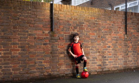 England’s united nations of football: 32 teams, one World Cup – and a lot of excited kids | World Cup 2022 7 Orson Berthier Ronald standing against a wall with his foot on a football, wearing the red-and-black Belgium kit