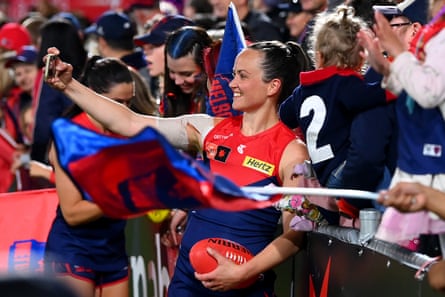 Pearce poses for selfies with fans after the Dees won the qualifying final.