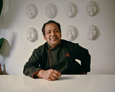 An older chef smiling.