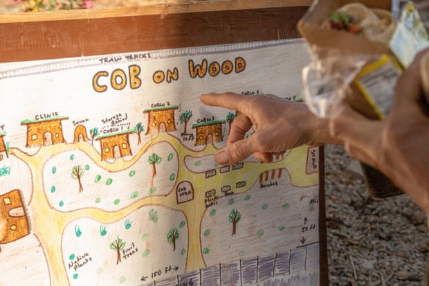 Miguel ‘Migz’ Elliott points to plans to expand Cob on Wood, including a new sauna, fruit trees, and ‘cobins’ that can house community members.