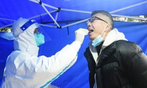 A man undergoes a nucleic acid test for Covid-19 in Hangzhou, China