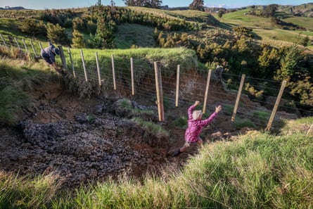 Karyn and Sue inspect fences damaged by a landslide on their farm.