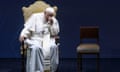 Pope Francis sitting on a stage in Rome