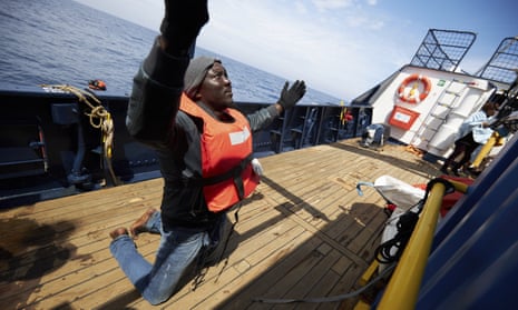 A man prays on the deck of the Sea-Watch humanitarian ship, Alan Kurdi