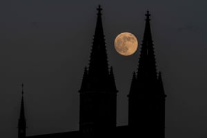 The supermoon rises behind the Basilica of St Peter and St Paul, part of Vysehrad castle, in Prague in the Czech Republic