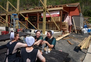 People sit at a picnic table