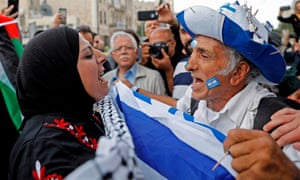An Israeli man confronts a Palestinian woman at Damascus gate in Jerusalem on Sunday as Israeli settlers celebrate Jerusalem Day in the Old City