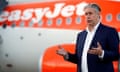 He gestures in front of an easyJet liveried aircraft