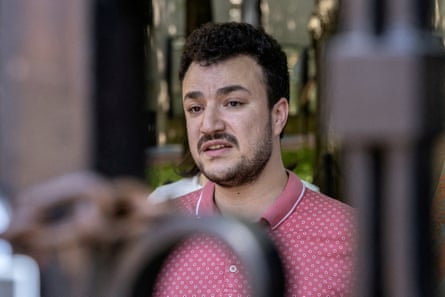 a man speaks through a gate