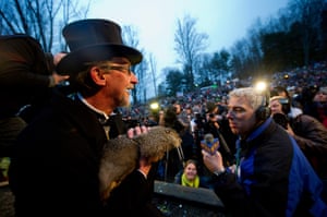 Handler Ron Ploucha holds Punxsutawney Phil during Groundhog Day celebrations in Pennsylvania. On leaving his burrow, Phil saw his shadow, which is said to augur six more weeks of winter.