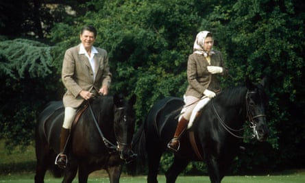 The Queen rides through Windsor Home Park with Ronald Reagan in 1982.