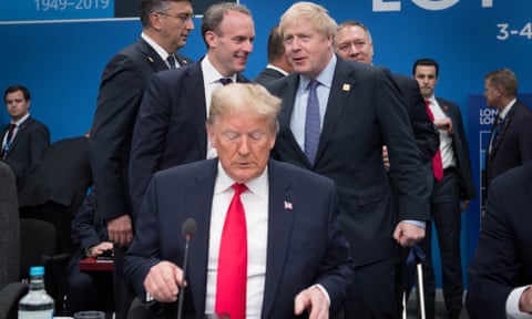 Dominic Raab and Boris Johnson behind Donald Trump on stage at the Nato heads of government summit in Watford