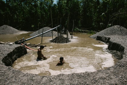 Illegal gold miners extract gold from sediment on the Marañón river
