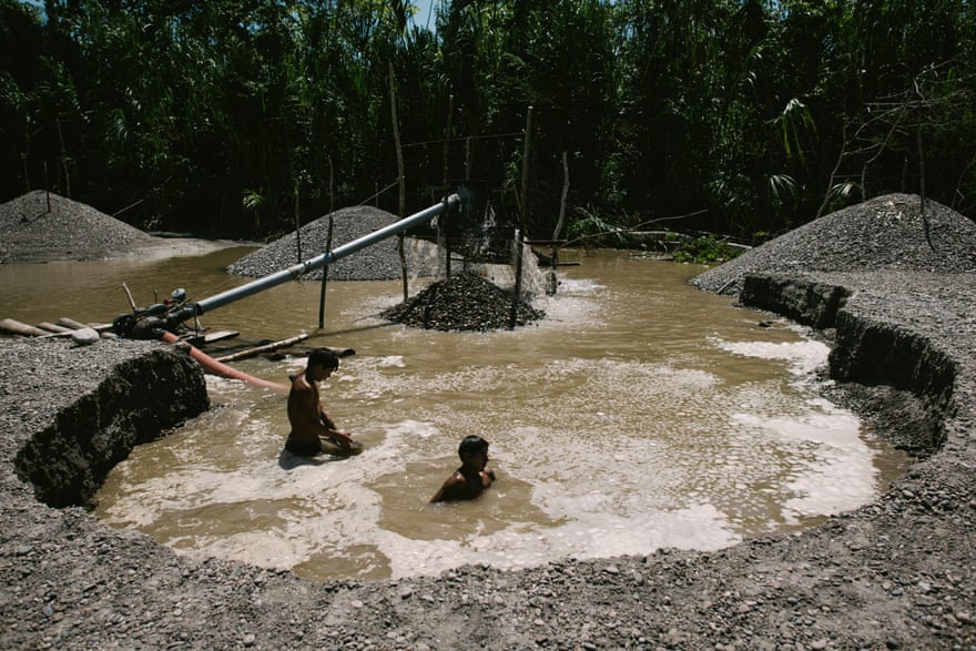Illegal gold miners extract gold from sediment on the Marañón river