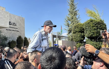 People hold aloft a released prisoner