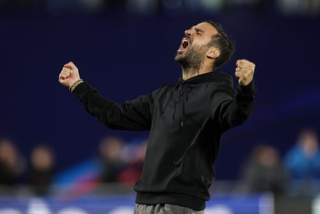 Como coach Cesc Fabregas celebrates, shouting with both fists clenched in the air