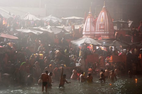 Hindu devotees take a holy dip in the waters of river Ganges during Makar Sankranti, the first day of the Kumbh Mela festival, in Haridwar.