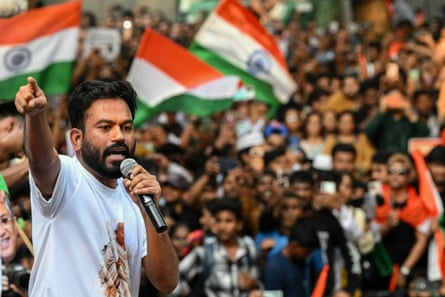 Abhijeet Dipke pointing with a mic in his hand standing in front of a large crowd