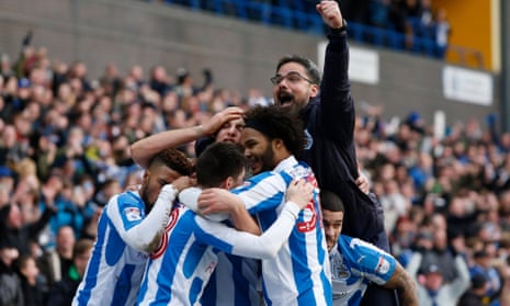 Huddersfield Town manager David Wagner celebrates with his players after their second goal, much to the chagrin of Leeds manager Garry Monk
